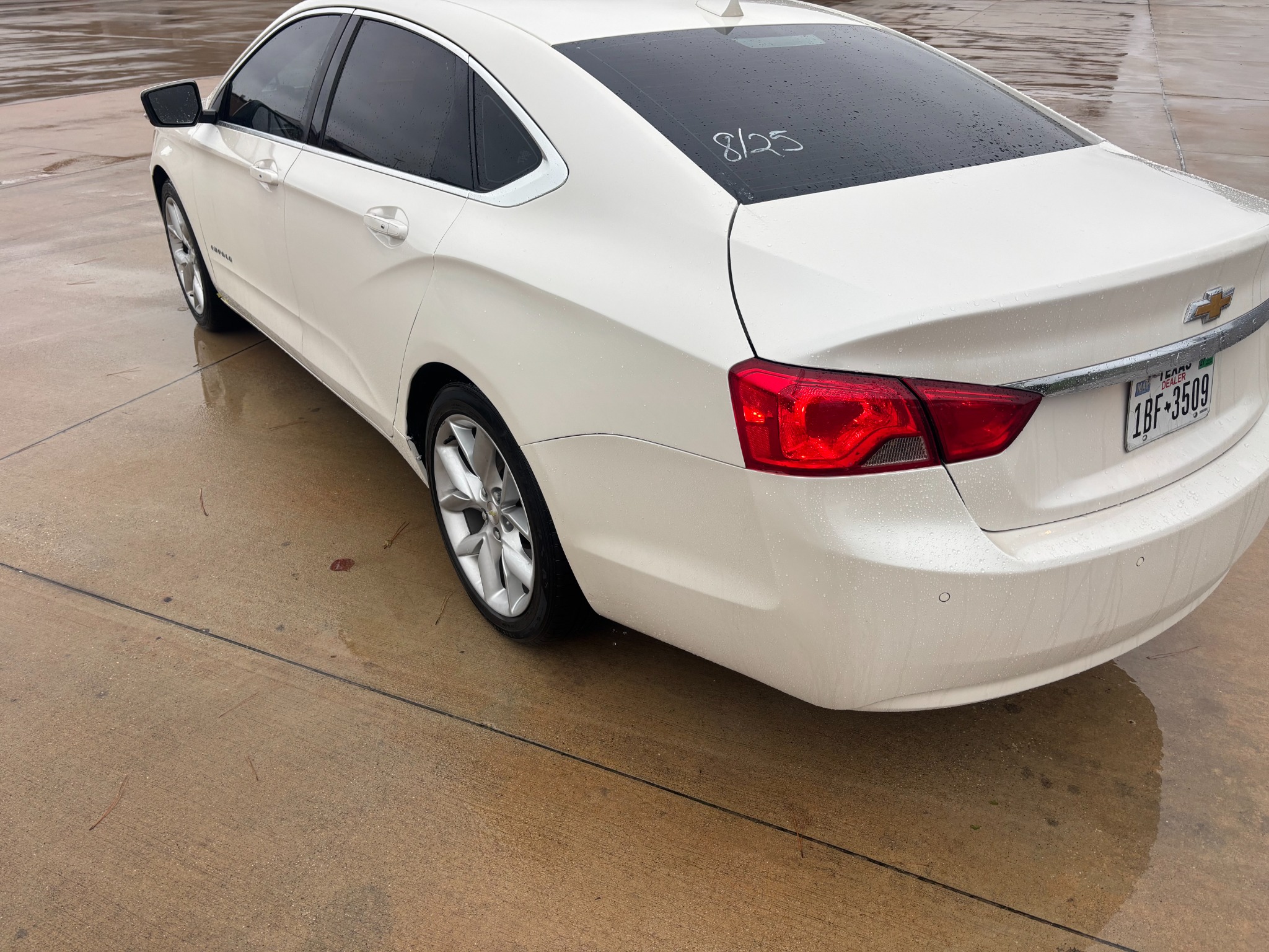 White Chevrolet Impala after rear bodywork, showing the repaired rear quarter, trunk and bumper.